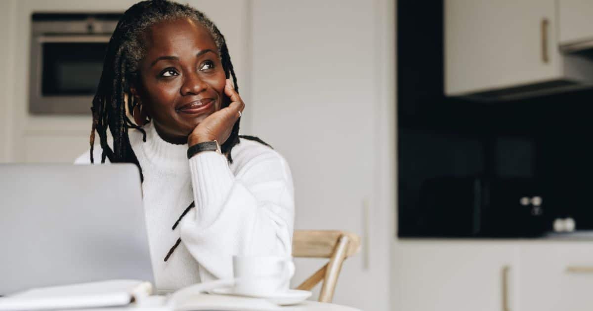 a woman sitting at her dining table wondering if hiring a matchmaker is the right choice for her