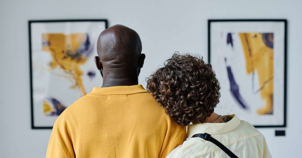 Couple looking at art in museum.