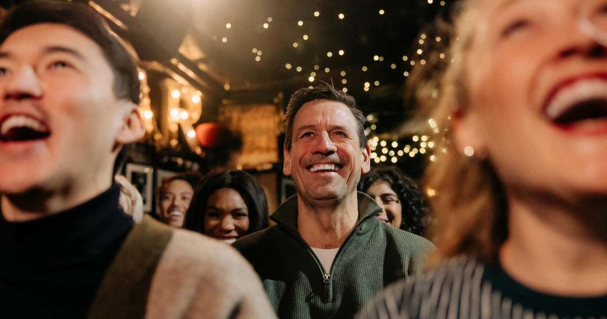 an audience at a comedy show laughing out loud