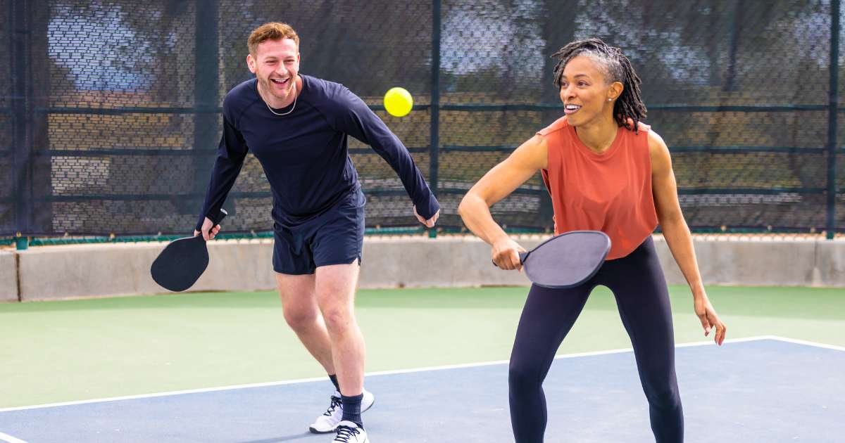 A couple in their 40s playing pickleball