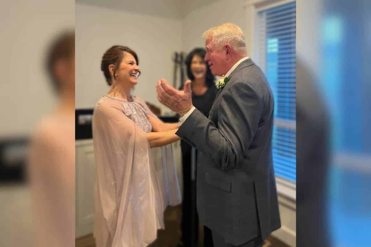 Todd and Jeanne smiling at one another during their wedding ceremony