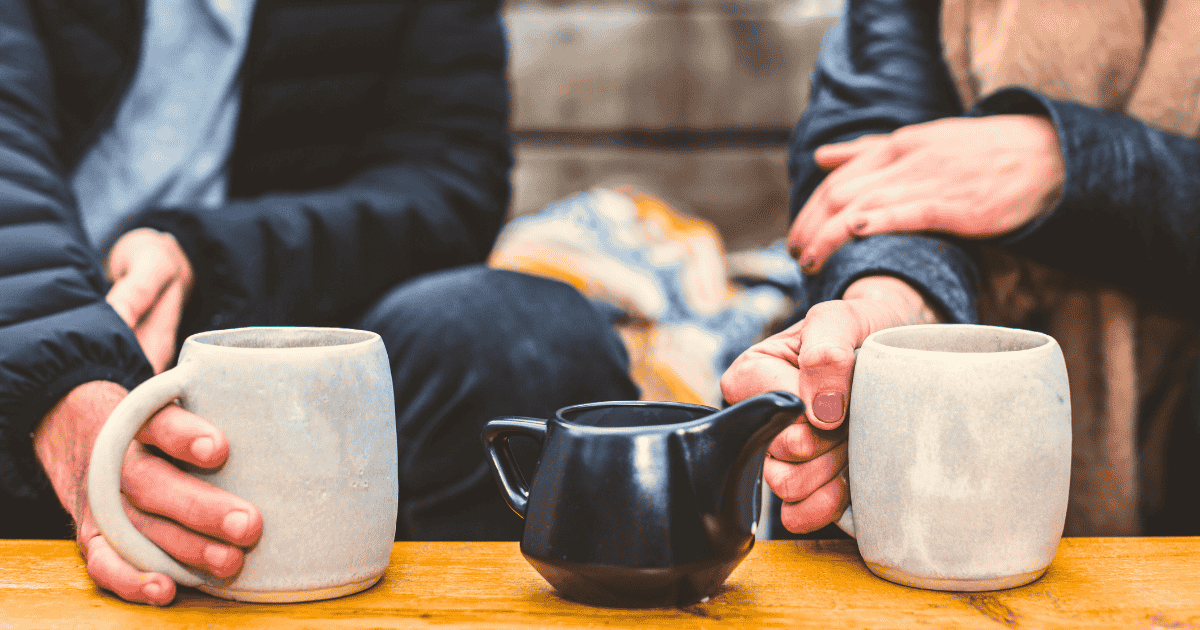 a man and woman having a date at over a pot of tea