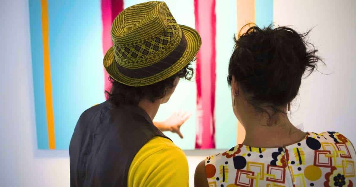 couple viewing a painting at an art gallery