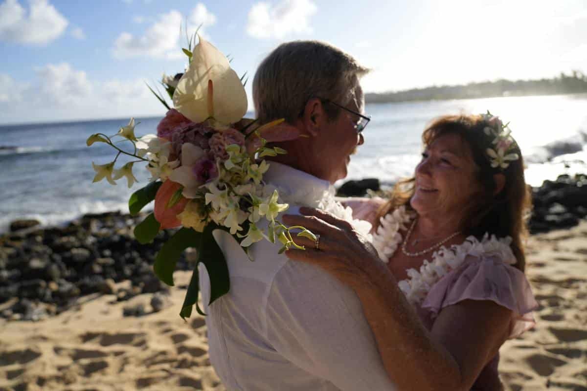 Mike and Ladona smiling lovingly at one another on their wedding day.