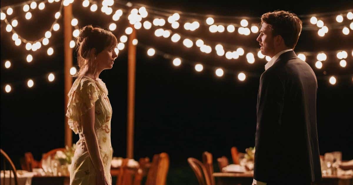 Lucy and John standing facing one another, in an emotional conversation