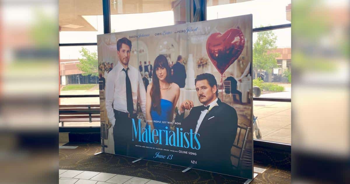 A Standee style poster for the film Materialists at the movie theater.