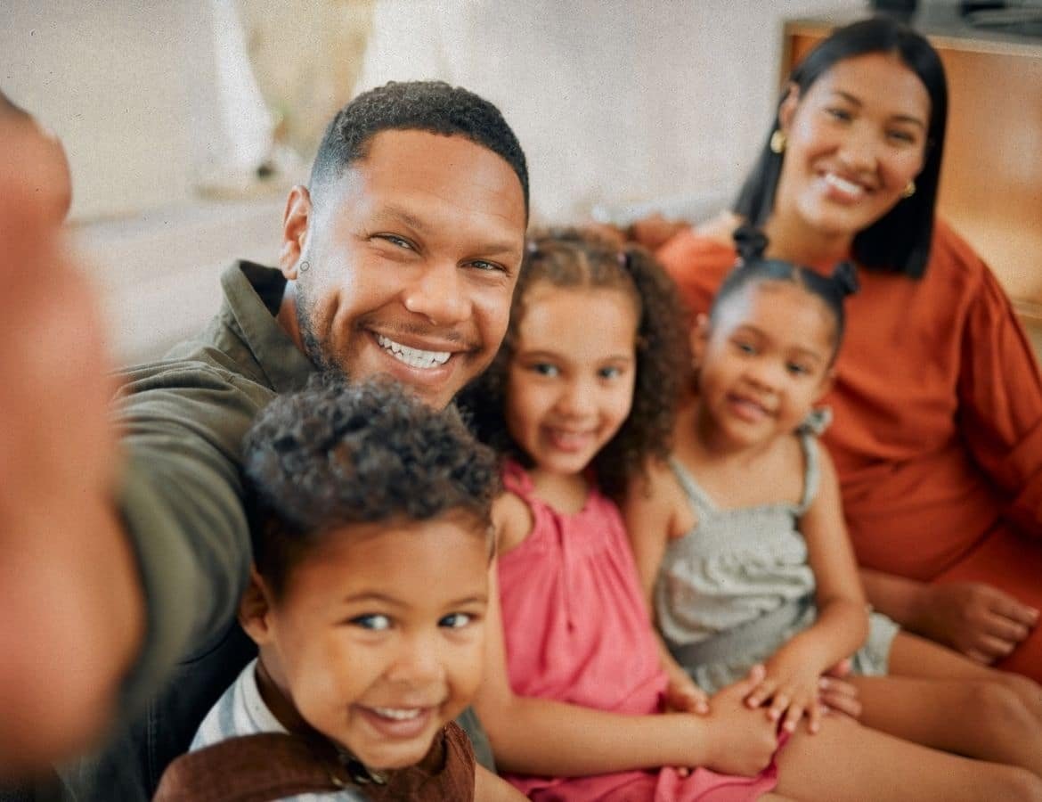 A happy family taking a selfie together, showing the long-term success of the matchmaking journey
