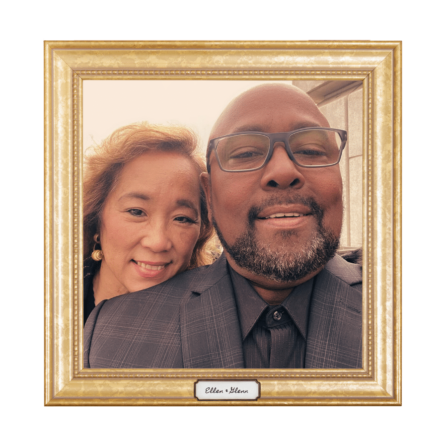 Close-up selfie of a happy interracial couple in an ornate gold frame