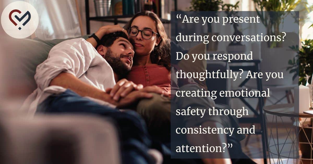 Affectionate couple sitting together on a couch and enjoying quiet time, reflecting emotional safety and healthy relationship connection